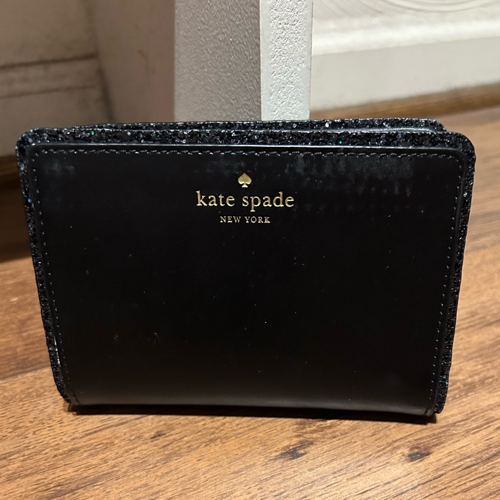 Kate Spade black leather bifold wallet with sequence trim